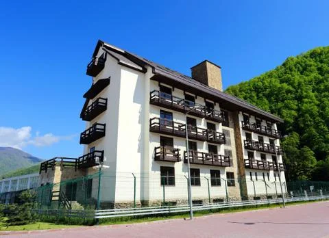 Multi-storey building on a background of a hill Stock Photos
