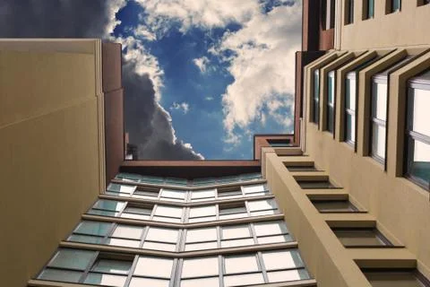 Multi-storey building on the background of the sky with clouds. Stock Photos