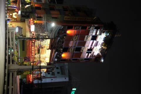 A multi-storey building backlit by lights on the street of a night Asian city. Fotos de archivo