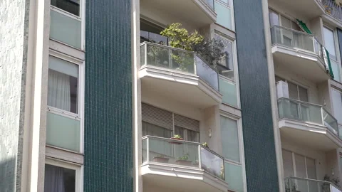 Multi-storey building. Facade of a beautiful balcony with fresh flowers. Video stock 256026147