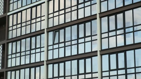 Multi-storey building with panoramic windows on the facade in city. Video stock 145543201