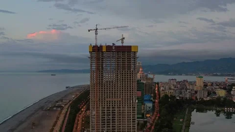 Multi-storey building under construction on the sea coast, aerial view Video stock 152036470