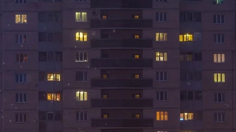 Multi storey building viewed in the snowy winter evening Stock Footage 71061653