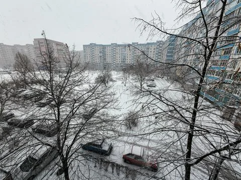 Multi-storey buildings in the snow. Winter in the city. Snowfall near high-.. Фото
