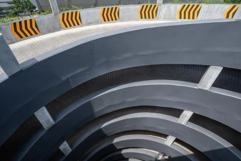 Multi-storey car parking. Circular ramp in the multi Level parking garage. Stock Photos