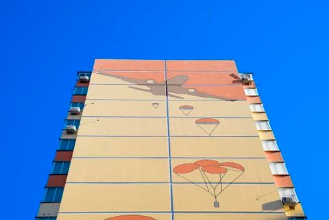 A multi-storey house with a painted wall. Figure depicting the landing of par Stock Photos