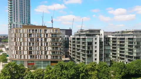 Multi-storey houses lined by road and trees Video stock 156703399