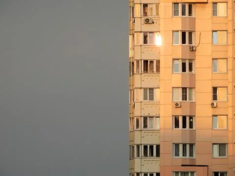 Multi-storey residential building in the rays of the setting sun Stock Photos