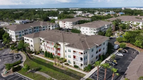 Multi-story apartment complex spans lush green property in Clearwater, Florida Stock Footage 339225814