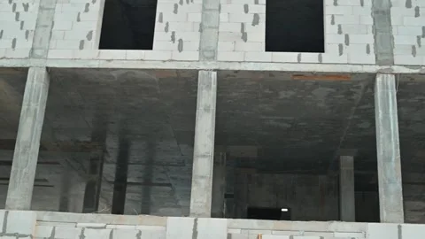 A multi-story building is under construction with exposed concrete and open Video stock 339095764