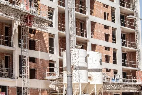 Multi-story building under construction with concrete floors, support columns Stock Photos