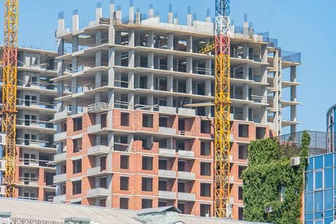 A multi-story construction site under progress, featuring concrete and bric.. Stock Photos