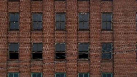 Multi-story red brick abandoned factory in industrial area Stock Footage 104872220
