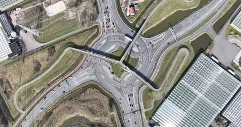 Multi story traffic round about, cars, road, bicycle path and foot going Stock Footage 304572559