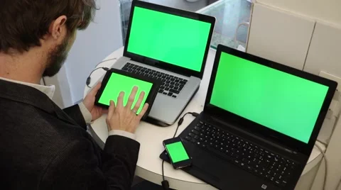 Multi-task online devices working man green screen - 1080p Stock Footage 55097464