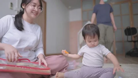 Multi tasking mother caring her daughter and answering husband's question Video stock 150552921