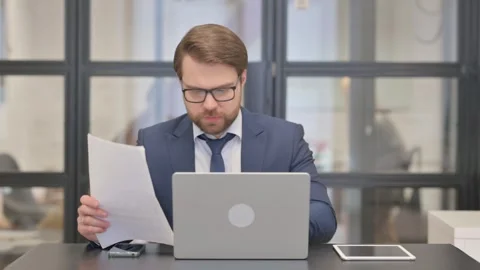 Multi Tasking Young Businessman Celebrating Successful Contract Stock Footage 273018101