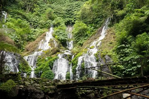 Multi-Tier Pucak Manik Waterfall with Bamboo Bridge, Buleleng Bali Stock Photos
