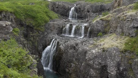 Multi-Tiered Waterfall Cascading Over Rocky Cliffs in Iceland 4K Nature Footage Stock Footage 339737417