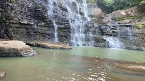 Multi-tiered Waterfall Cascading into Pool, Tropical Forest, Wide Shot Video stock 324771840