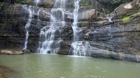 Multi-Tiered Waterfall Cascading into Serene Pool, Rocky Jungle, Wide Shot Stock Footage 324771006