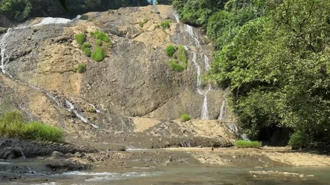 Multi-Tiered Waterfall Flowing Over Rocky Hillside, Lush Forest, Serene Nature S Stock Footage 325303906
