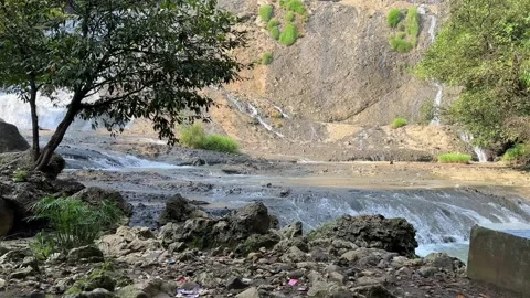 Multi-Tiered Waterfall Flowing Over Rocks, Lush Nature, Pull Focus Shot 스톡 동영상 325646186