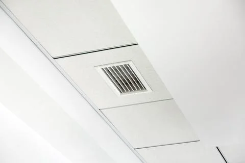 Multi-tiered white plasterboard ceiling and tiled square suspended ceiling. Stock Photos