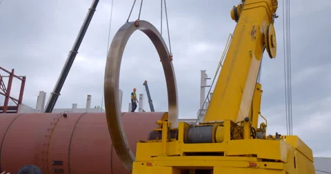 A multi-ton crane lifted a huge heavy metal ring to mount it to a large tank Stock Footage 161992819