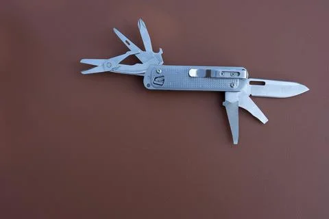 Multi tool on back red ground Stock Photos