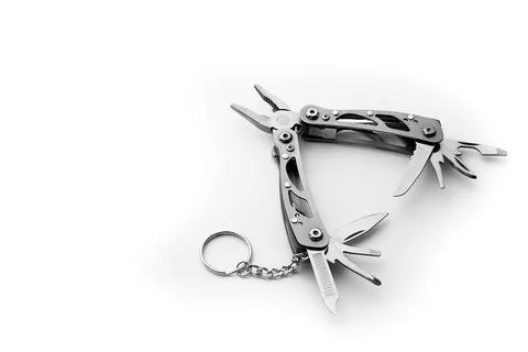 Multi tool with expanded tools and pliers isolated on a white background. Stock Photos