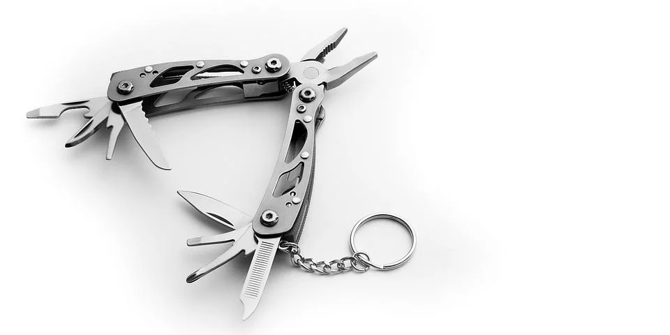 Multi tool with expanded tools and pliers isolated on a white background. Stock Photos