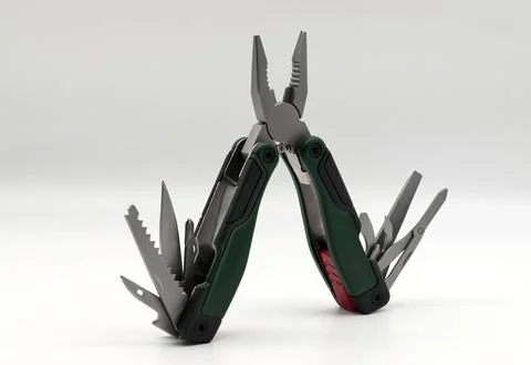 Multi tool with multiple functions and pliers isolated on white. Foto stock