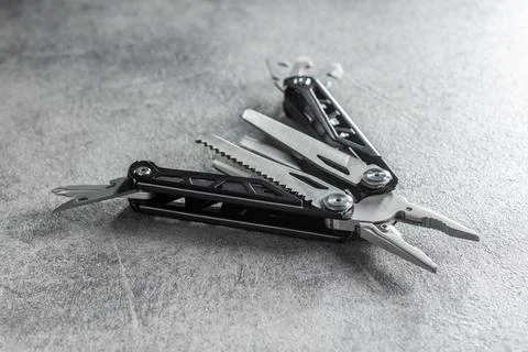 Multi-tools pliers with other tools and knife. Multifunction pliers. Stock Photos