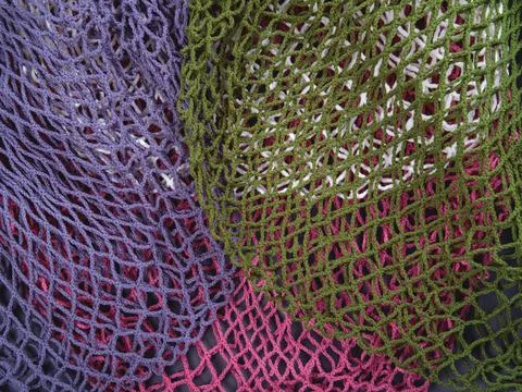 The multicolor background of the zero waste string bags, closeup of the knitt Stock Photos