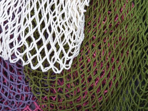 The multicolor background of the zero waste string bags, closeup of the knitt Stock Photos