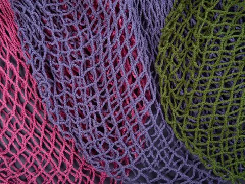 The multicolor background of the zero waste string bags, closeup of the knitt Stock Photos