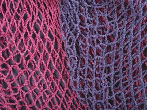 The multicolor background of zero waste string bags, closeup of the knitted net. Stock Photos