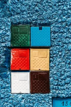 Multicolor boxes on blue wall: A lively fusion of colors, these vibrant box.. Stock Photos
