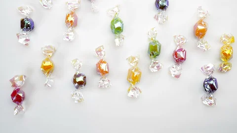 Multicolor candies on white background  stop motion animation 4k Stock Footage 128920762