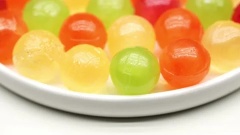 Multicolor Candy Falls on White Background Stock Footage 234997108