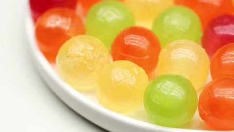Multicolor Candy Falls on White Background Stock Footage 234997159