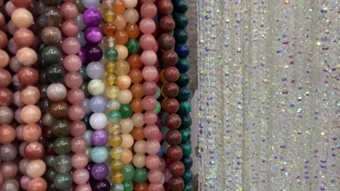 Multicolor children's necklaces and bead bracelets on a shop display. Stock Footage 331604014