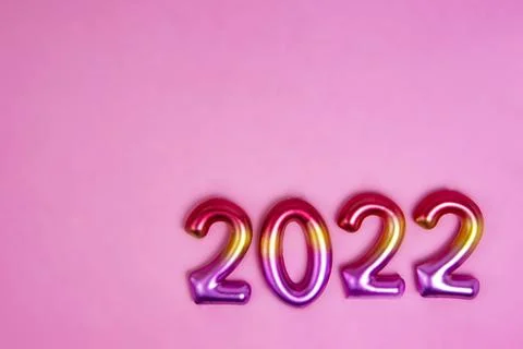 Multicolor creative 2022 numbers on decorative pink background with copy spac Stock Photos