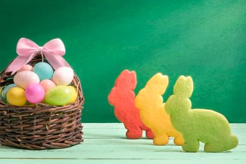 Multicolor Easter eggs and bunny shaped cookies Stock Photos