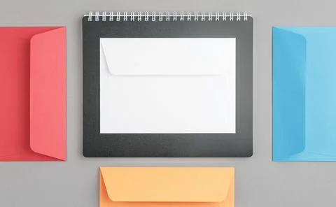 Multicolor envelopes with a notepad. Stock Photos