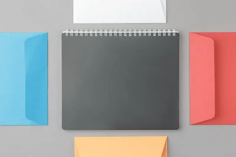 Multicolor envelopes with spiral notepad. Foto stock