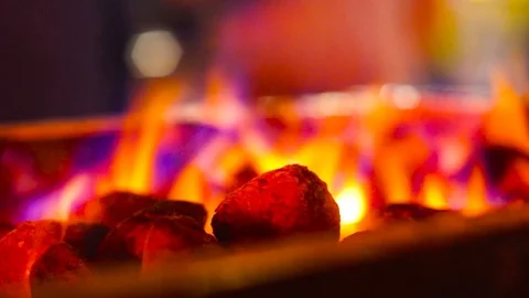 Multicolor fire blazing over barbecue campfire coals shot with a shallow depth Stock Footage 104051554