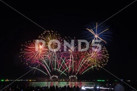Multicolor Fireworks Display Exploding Over Waterfront Crowd Night Landscap.. Photos