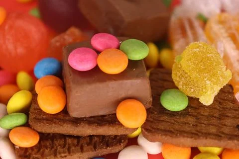 Multicolor Gems on the chocolate biscuits make a beautiful portrait Stock Photos